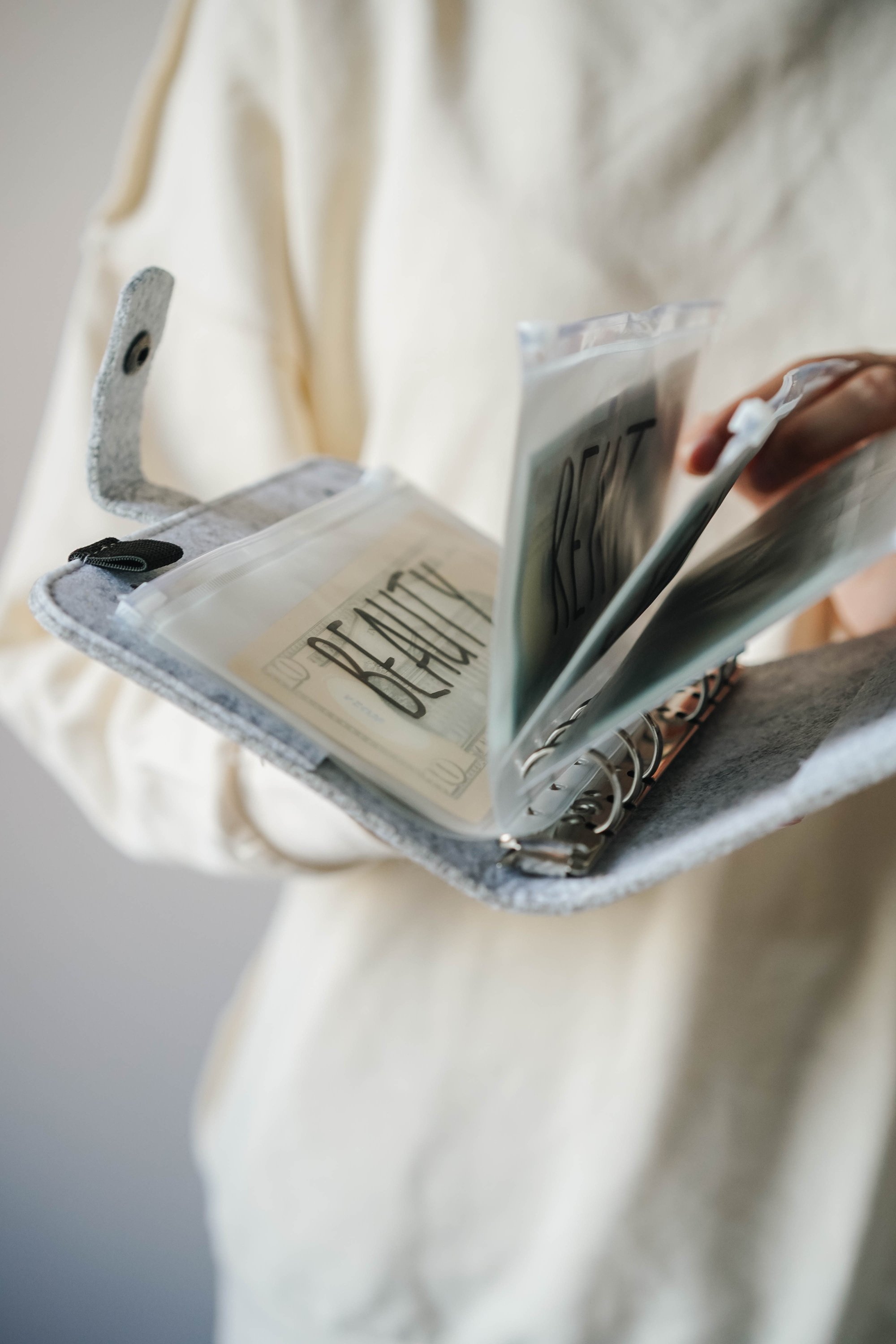 Woman Holding a Book Binder with Bills