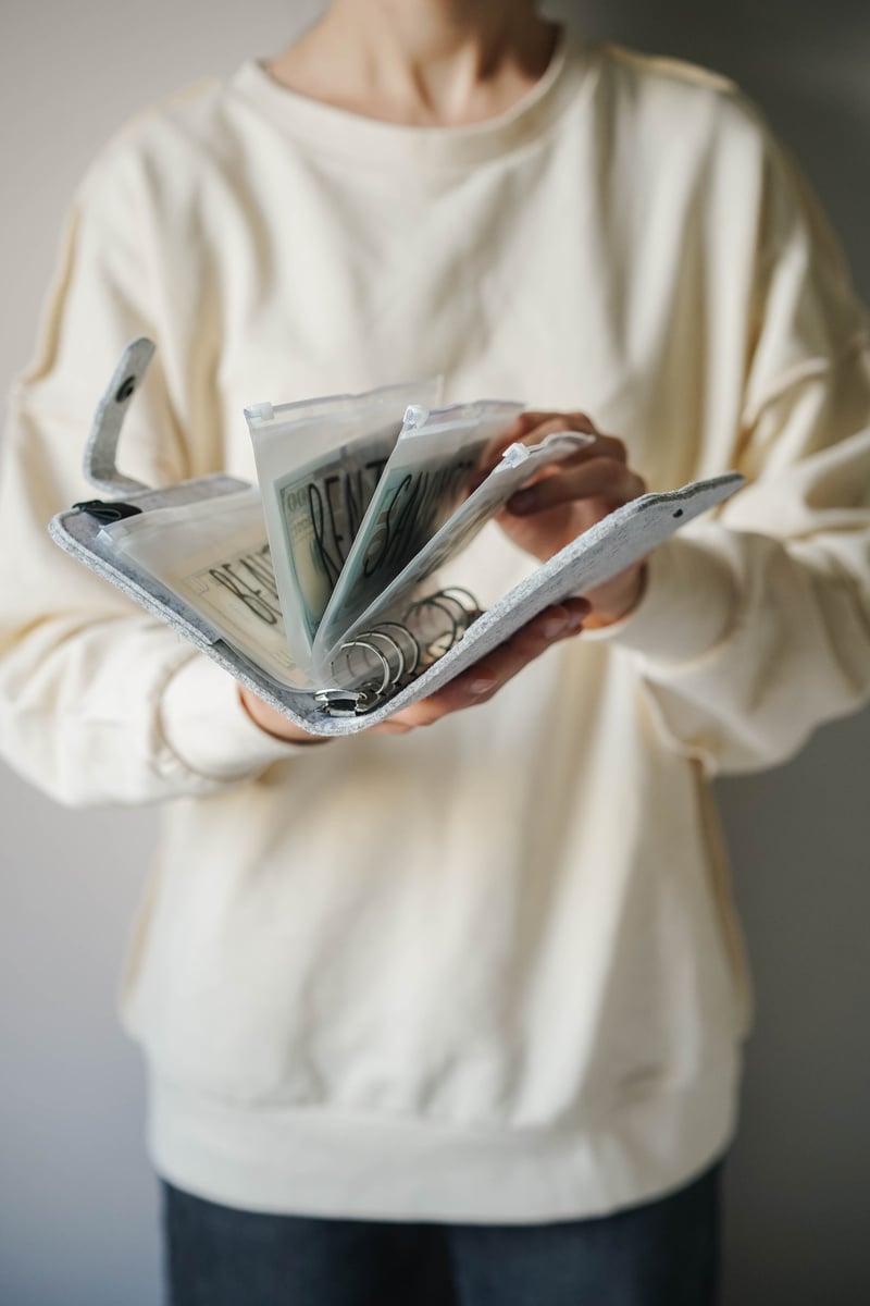 Woman Holding a Book Binder with Bills